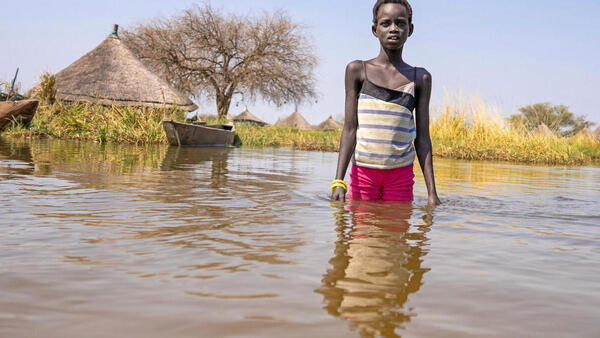 Twelve-year-old Alekiir stands in floodwater outside the village of Panyagor in Twic East, Jonglei State, South Sudan. 