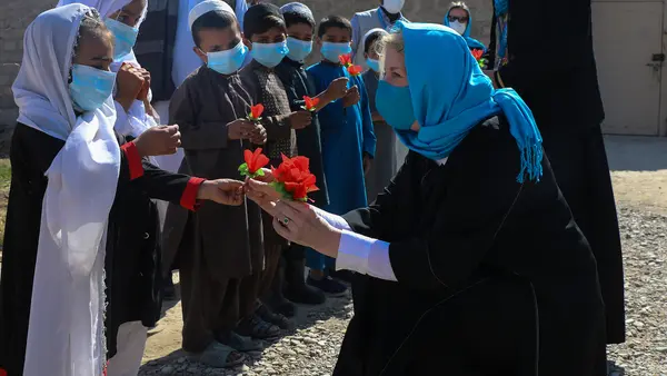 In Afghanistan on Feb. 24, 2022, UNICEF Executive Director Catherine Russell is greeted by students at a UNICEF-supported community-based school in Kandahar’s Dand district.