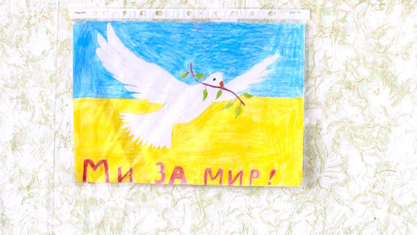 A child's drawing promoting peace hangs on the wall of an empty school in eastern Ukraine on February 10, 2022. 