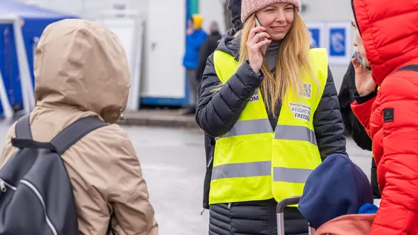 Anastasia, a refugee from Ukraine, volunteers as a translator for newly arrived families at a UNICEF Blue Dot center in Siret, Romania.