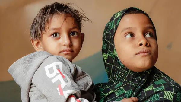 3-year-old Aseel of Al Hudaydah, Yemen, held by his cousin, is recovering slowly after treatment for severe acute malnutrition with UNICEF's help.