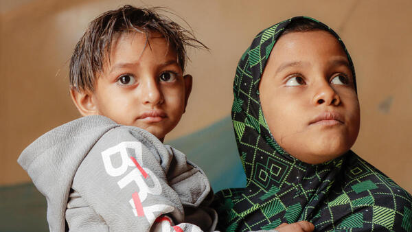 3-year-old Aseel of Al Hudaydah, Yemen, held by his cousin, is recovering slowly after treatment for severe acute malnutrition with UNICEF's help.