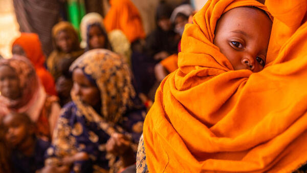 On April 11, 2022, a mother and a baby wait at a health post in Ba’adley, IDP Site, Shabelle Zone, Somali Region, Ethiopia.