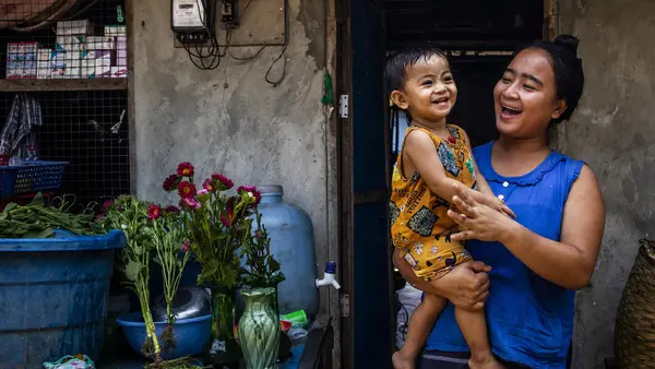 Pan Ei, 20 months old, and her mother play outside their hostel in A Lal village, Hlaing Thar Yar township, Yangon, Myanmar on April 4, 2022. 