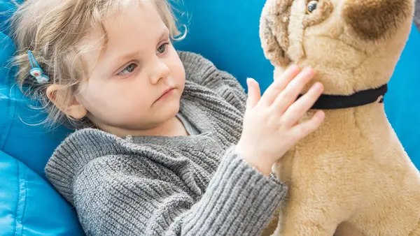 A child play with her toy in the activity room in a UNICEF-UNHCR Blue Dot center in Brasov, Romania