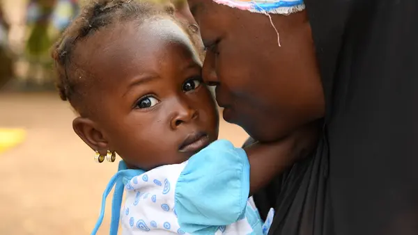 A mother and child attend a malnutrition screening session in the village of Ngolo, northern Burkina Faso.