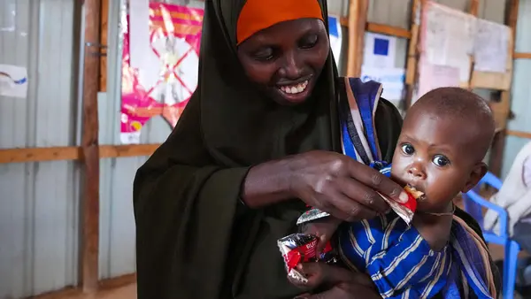 On May 24, 2022, 10-month-old Ubah is fed Ready-to-Use Therapeutic Food by her mother at UNICEF-supported Dollow Health Center in Somalia. 