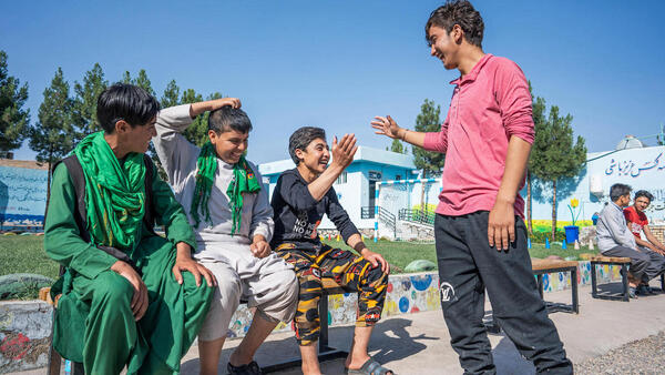 Adolescent boys who are returning migrant workers greet each other at the UNICEF-supported Gazargah Transit Center in Herat, Afghanistan.
