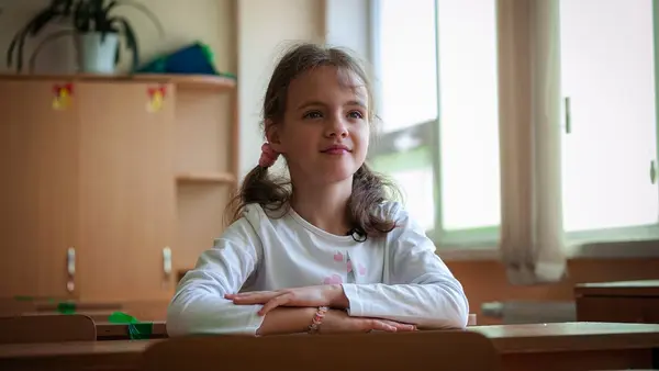 A 10-year-old girl from Ukraine sits in her new classroom at a school in Moldova that is welcoming refugee children with UNICEF's help.