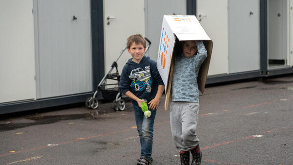 Children Walking with Box Over Head