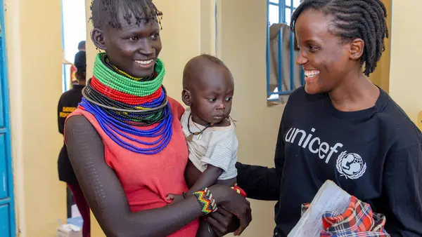 On Sept. 8, 2022, UNICEF's newest Goodwill Ambassador, Vanessa Nakate, right, with Asinyoni Ekiru, mother to 14-month-old Papos Alos at the UNICEF-supported Kobuin Health Center in Turkana County, Kenya. 