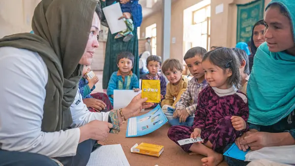 Fatima Adeli, a doctor with a UNICEF-supported mobile health and nutrition team, counsels children and mothers in Safeedi-Mish village in the Nili district of Daikundi Province, central Afghanistan, on Oct. 3, 2022.