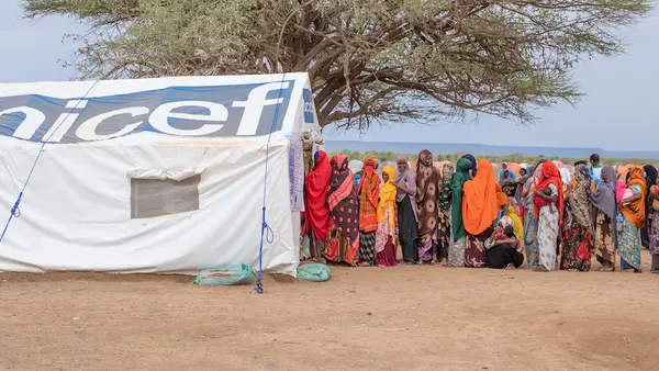 Women and children queue for health and nutrition services from UNICEF and partners at the Higlo site for displaced families in Ethiopia.