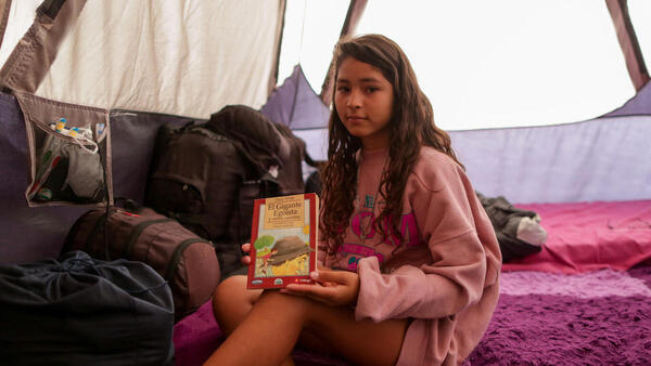 Thirteen-year-old Valeria in her family's tent at a UNICEF-supported humanitarian camp for migrant families located in Playa Lobitos, Iquique, northern Chile, on April 26, 2022.