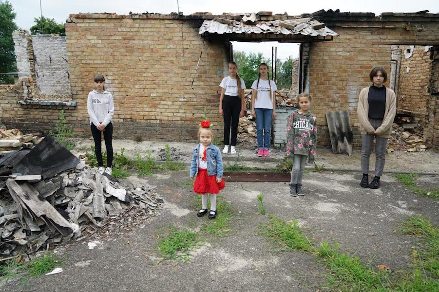 Kids in Front of Destroyed Building