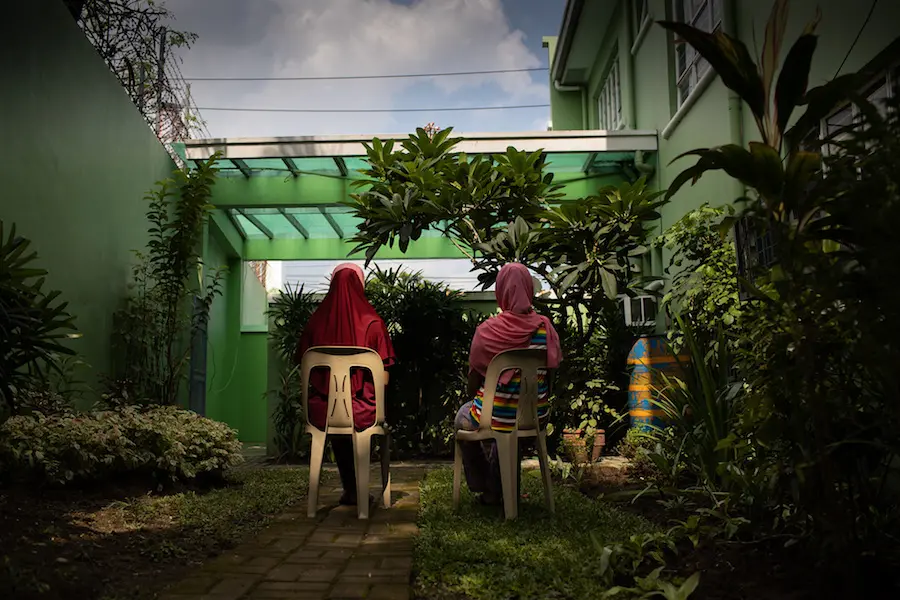 Two People Sitting in Chairs