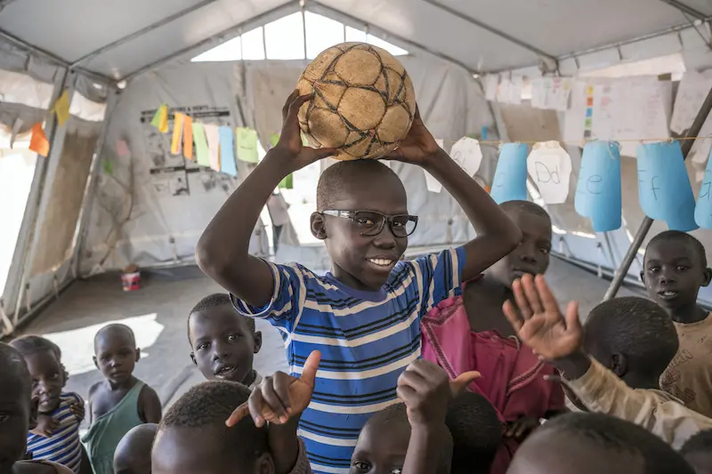 Justin in Uganda boy with soccer ball body shot