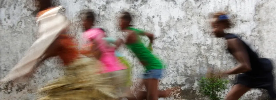 Girls run and play at a transition centre for children in contact with the law
