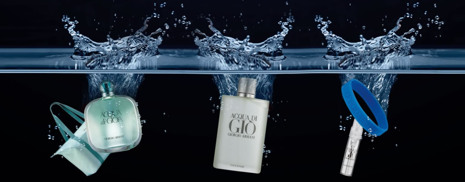 Three different Giorgio Armani products splashing down into water over a black background
