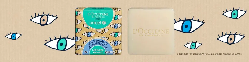 Image of square soap, one in its Solidarity Soap packaging and one without it, on a tan background with illustrated eyes