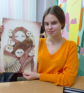 young lady holding a piece of artwork