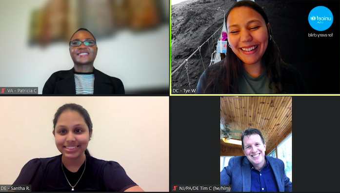 four smiling individuals during a video conference