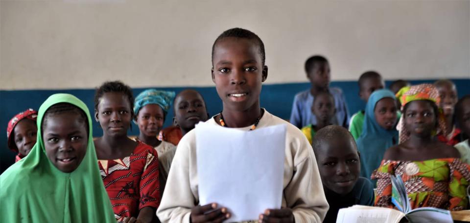 Gilbert, a 14-old Nigerian refugee living in Cameroon, holds a letter he wrote in reply to the question, "What does education mean to you?" 