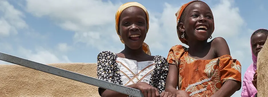 At a displacement camp in Garin Wazam, Niger, two girls pump water from a new borehole installed by UNICEF and partners.