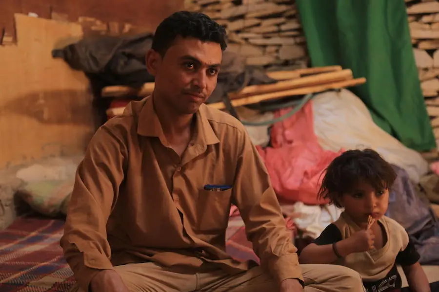 Waleed Al-Ahdal, 25, and his 3-year-old son, Khalid, in their tent in a camp for internally displaced families in Yemen's Marib governorate.