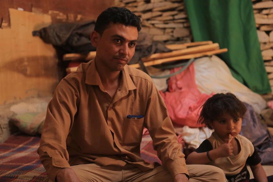 Waleed Al-Ahdal, 25, and his 3-year-old son, Khalid, in their tent in a camp for internally displaced families in Yemen's Marib governorate. 