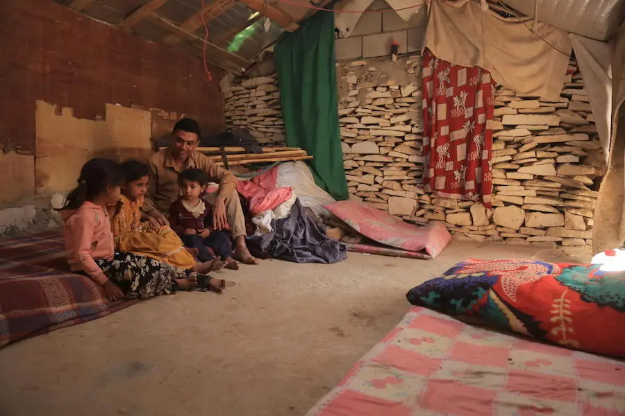 Waleed Al-Ahdal, 25, and his children in the family's shelter in a camp for internally displaced families in Yemen's Marib governorate.