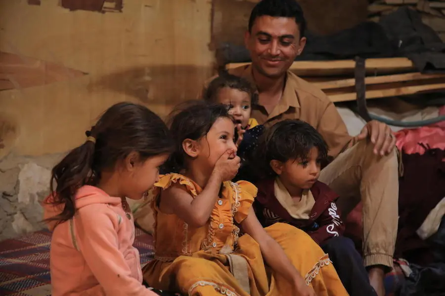 Waleed Al-Ahdal, 25, and his children in their current home in a camp for internally displaced families in Yemen's Marib governorate.