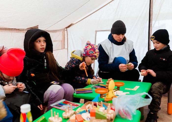 On March 16, 2022, children fleeing war in Ukraine play at a UNICEF Blue Dot Center at the Palanca border crossing in Moldova.