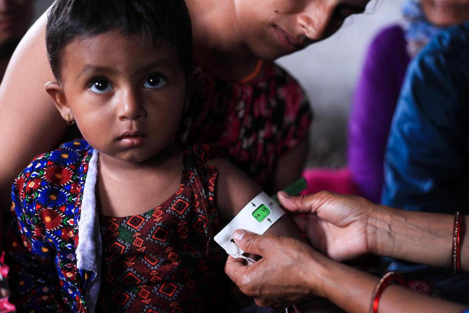 In Jorayal, a community in the Doti district in far-western Nepal, a UNICEF-supported health worker screens a child for malnutrition.