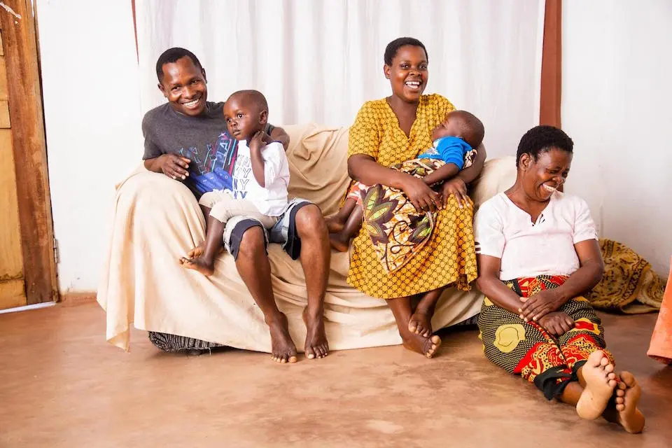 Robert Mwale, 29, left, a fisherman based in Tukombo, celebrates his recovery from cholera.