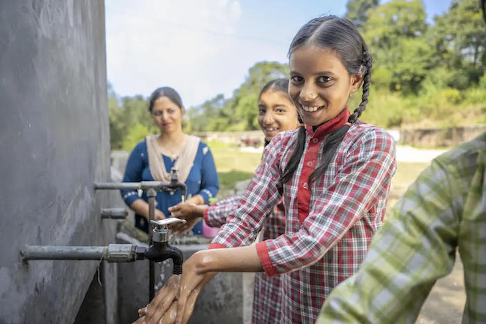 Shaily, 11, uses a handwashing station UNICEF helped install outside her middle school in Himachal Pradesh, India.