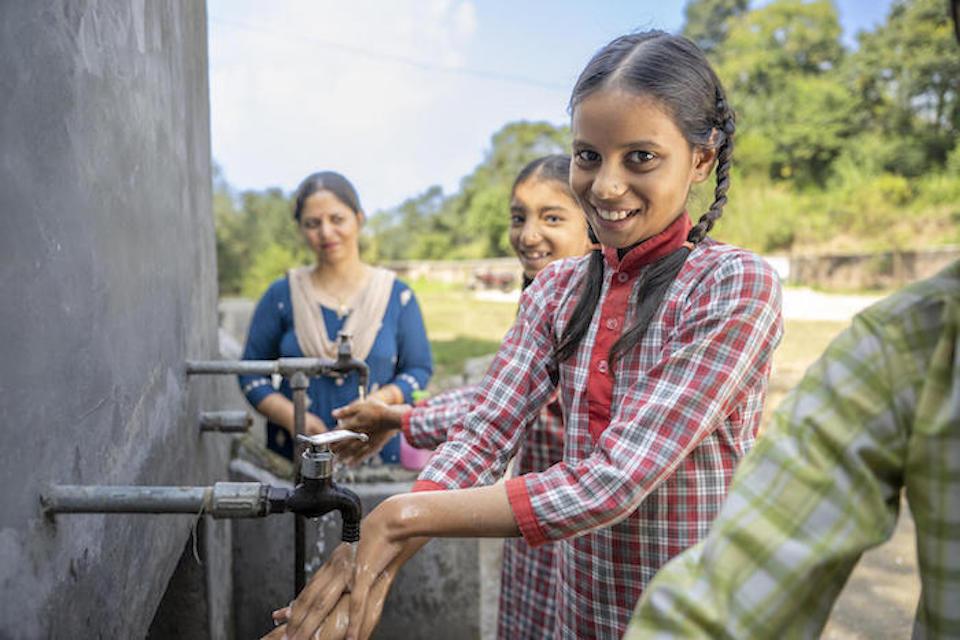 Shaily, 11, uses a handwashing station UNICEF helped install outside her middle school in Himachal Pradesh, India. 