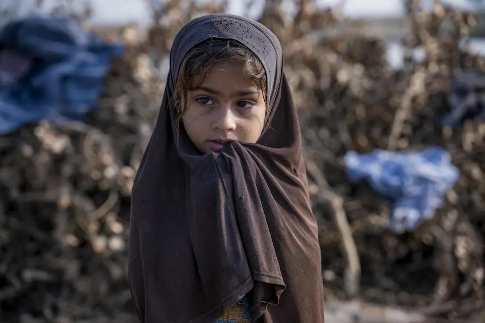 Four-year-old Fatima stands outside her family's tent in Zangi Brohi Village, Dadu District, Sindh.