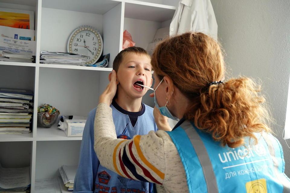 Pediatrician Nataliya Strunenko performs an examination of a boy as part of the work of the UNICEF mobile medical team in the village of Maryanivka in Ukraine's Kyiv region.