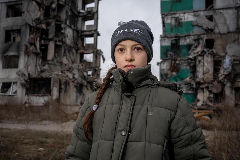 Veronica, 10, returns to feed the stray cats that roam the ruins of the apartment building in Borodianka, Ukraine, where she lived with her family before the war escalated. 