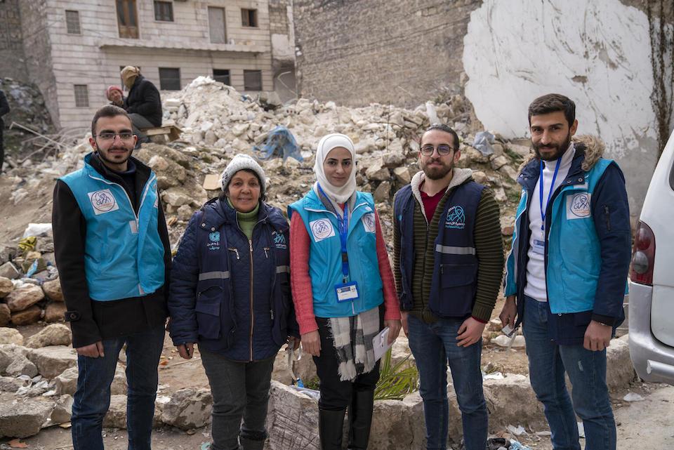 On Feb. 10, 2023, from left: Amr, 24, Fayzeh, Hiba, Sameh, 24, and Mohammad, 28, stand in front of the rubble of a building that collapsed during the earthquake in Aleppo's Alsalheen neighborhood. 