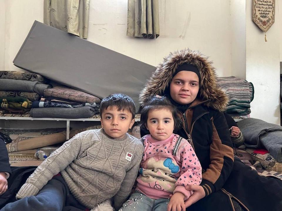 Siblings Molham, 7, Hala, 4, and Nour, 13, wait to see a UNICEF health team in Aleppo's Sleiman Alhalabbi neighborhood. 