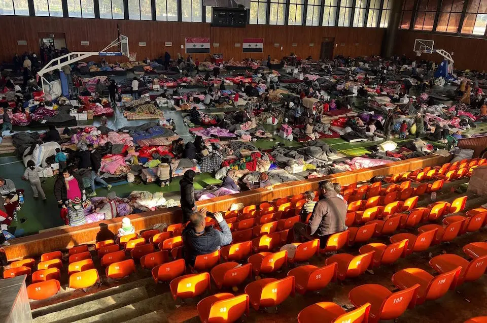Families took shelter at a sports complex in Lattakia, Syria, after a pair of massive earthquakes destroyed thousands of homes and left others structurally unsafe in Syria and Turkey on Feb. 6, 2023.