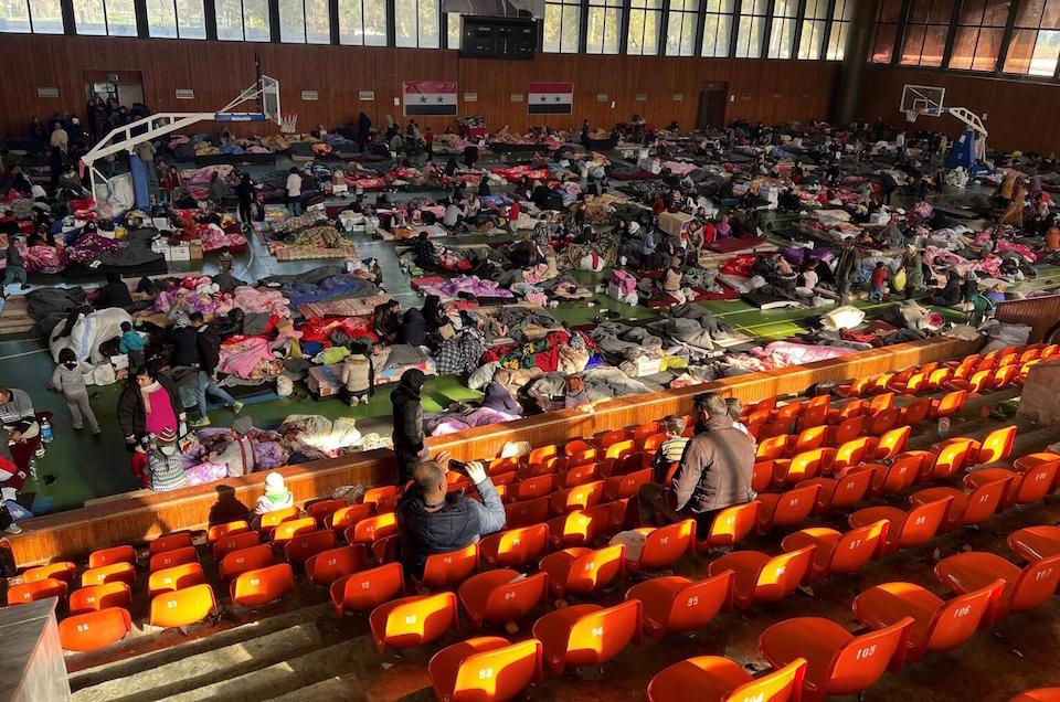 Families took shelter at a sports complex in Lattakia, Syria, after a pair of massive earthquakes destroyed thousands of homes and left others structurally unsafe in Syria and Turkey on Feb. 6, 2023. 