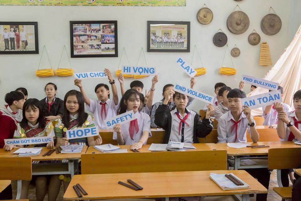 At a World Children's Day celebration in 2018, students at a UNICEF-supported school in Vietnam hold up signs showing some of their hopes for the future — dreams shared by young people everywhere.