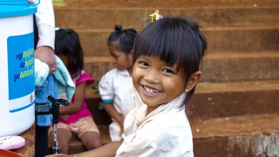 A girl washes her hands at a UNICEF-supported school in Cambodia.