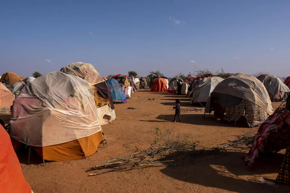 A child walks among tents at a site for internally displaced persons in Somalia, near the border with Ethiopia. 