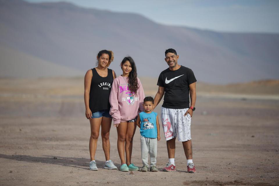 After a long journey from Venezuela, 13-year-old Valeria, in pink, her mother, father and 3-year-old brother, Adriel, are staying in a UNICEF-supported transit center for  families on the move in Playa Lobitos, Iquique, northern Chile.