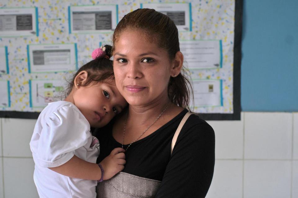 A mother holds her 3-year-old daughter close during a UNICEF-supported nutritional care service day in the Morichalito community, Bolívar state, Venezuela.
