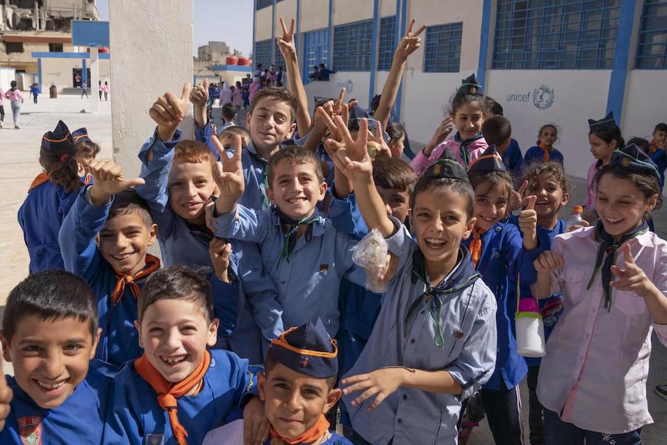 Students on a break from classes play in a school yard in Baba Amer, Homs City, Syria.